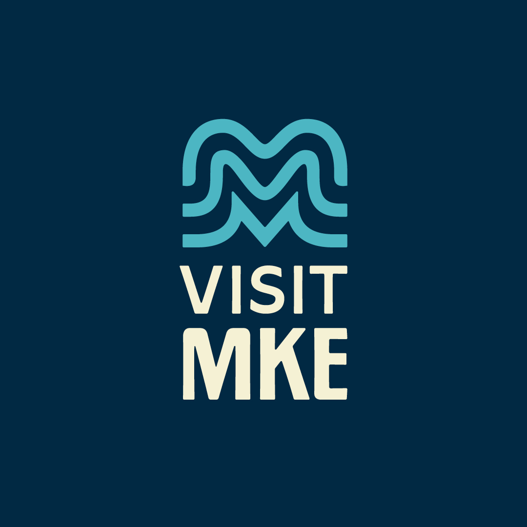 Visit Milwaukee logo, indicating official partnership with QDOBA Mexican Eats in Wisconsin.