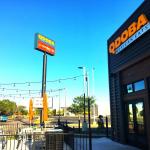 Photograph of the new QDOBA Mexican Eats Location exterior, outdoor patio, and sign in Delavan, WI.